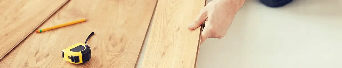 A professional installing wood flooring in Tampa, FL