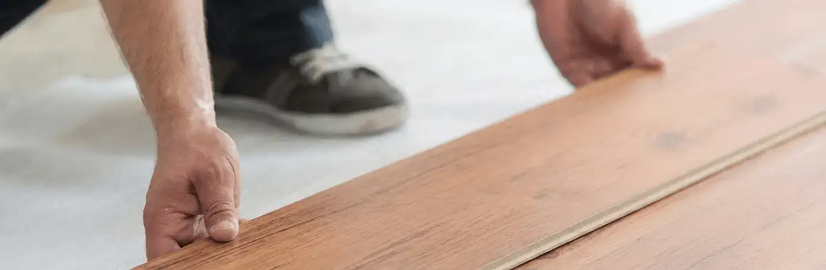 A professional installing laminate flooring in Tampa, FL